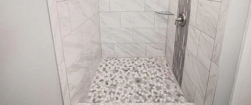 Shower with mosaic tiles as a focal point for this bathroom remodel done in Wesley Chapel, FL
