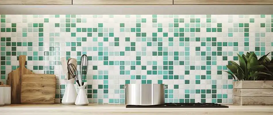 Green and white tiled backsplash that is in the kitchen of a Lakeland home.