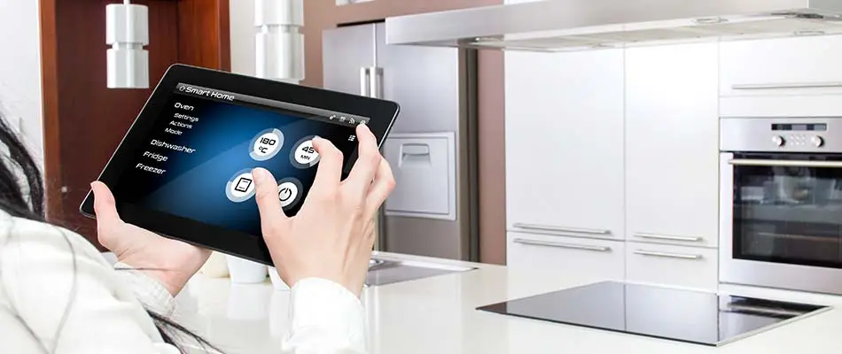 This homeowner in Winter Haven is controlling smart kitchen appliances from a tablet.