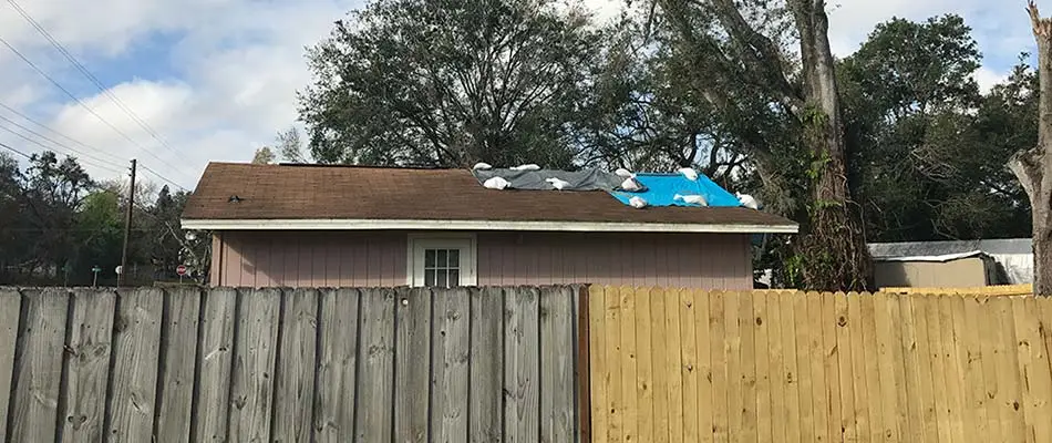 Roof damage from fallen tree during Hurricane Irma.