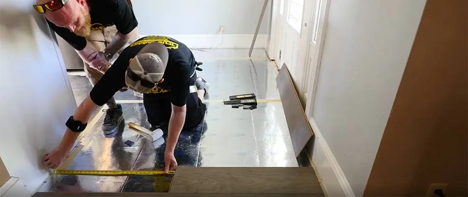 True Builders team members in the process of installing new flooring during a kitchen remodel in Dover, FL.